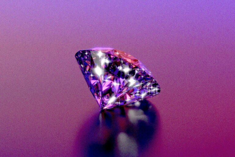A sparkly diamond shines on a purple background